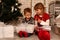 Children with gifts near a Christmas tree