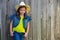 Children girl as kid cowgirl posing on wooden fence