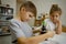 Children girl and boy preparing microscope at home in the room