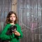 Children girl holding puppy dog on backyard wood fence