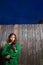 Children girl holding puppy dog on backyard wood fence