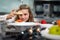 Children girl leaning cooking food.  Chef teacher teaches cooking to the group children in class kitchen room.