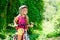 Children girl riding bicycle outdoor in forest