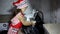 Children girl wash laptop in sink on kitchen. Wearing red apron.