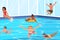 Children Girls and Boys Characters Joyfully Playing In Blue Swimming Pool, Jumping, Diving And Splashing Water