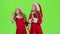 Children girls in the Christmas costumes inflate the stellar pollen. Green screen