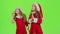 Children girls in the Christmas costumes inflate the stellar pollen. Green screen. Slow motion