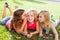 Children girls playing whispering on flowers grass