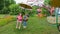 Children girls ride on a carousel in an amusement park