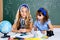 Children girls at school classroom with microscope