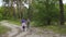 Children girls sisters walking by the pine forest