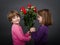 Children gives red roses