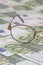 Children glasses fragment on green euro banknotes. Expensive eye treatment concept