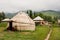 Children go away past Central Asian yurt village house