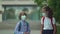 Children go back to school. Cute pupils with backpacks. Boy and girl in safety masks