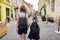 Children going to school, two girls sisters holding hands, back view