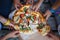 Children grab slices of pizza at the picnic