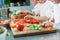 Children grind vegetables in the kitchen of a restaurant.