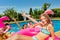 Children group play in pool with inflatable toys