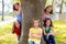 Children group of sisters girls and friends on tree trunk