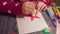 Children handicraft. Little girl glues New Year card
