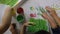 Children hands finger painting with various colors