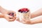 Children hands, holding raspberries and blueberries, basket with