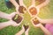 Children hands holding sapling in soil surface with plant