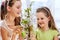 Children hang easter egg on cherry branch