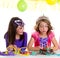 Children happy girls blowing birthday party cake