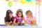 Children happy girls blowing birthday party cake