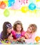 Children happy girls blowing birthday party cake