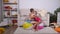 Children have fun sit and jump on large rubber inflatable balls in playroom