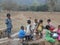 A Children have gathered in the hand pump  for water