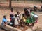 A Children have gathered in the hand pump  for water