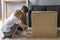 Children help renovate the wooden cabinet. Two boys paint the table with brushes. Restoring furniture