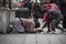 Children helping a beggar lady