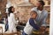 Children Helping Parents To Prepare Meal In Kitchen