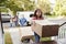 Children Helping Unload Boxes From Van On Family Moving In Day