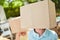 Children hide their faces under cardboard boxes