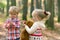 Children in hike in forest in search of mushrooms.