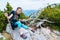 Children hiking on beautiful summer day in alps mountains Austria, resting on rock and admire amazing view to mountain