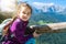 Children hiking on beautiful summer day in alps mountains Austria, resting on rock and admire amazing view to mountain