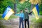 Children hold Ukrainian flags yellow and blue waving in wind . Ukraine\\\'s Independence Day.