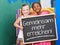 Children holding blackboard saying