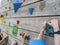 Children holding onto hand grips on a climbing wall