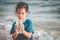 Children holding Plastic cup that he found on the beach for enviromental clean up concept