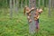 Children hug pine tree in a forest