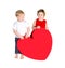 Children with huge heart made â€‹â€‹of red paper