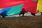 Children install a large colored canopy